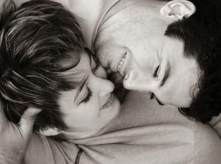 Sweet young couple lying on the rug